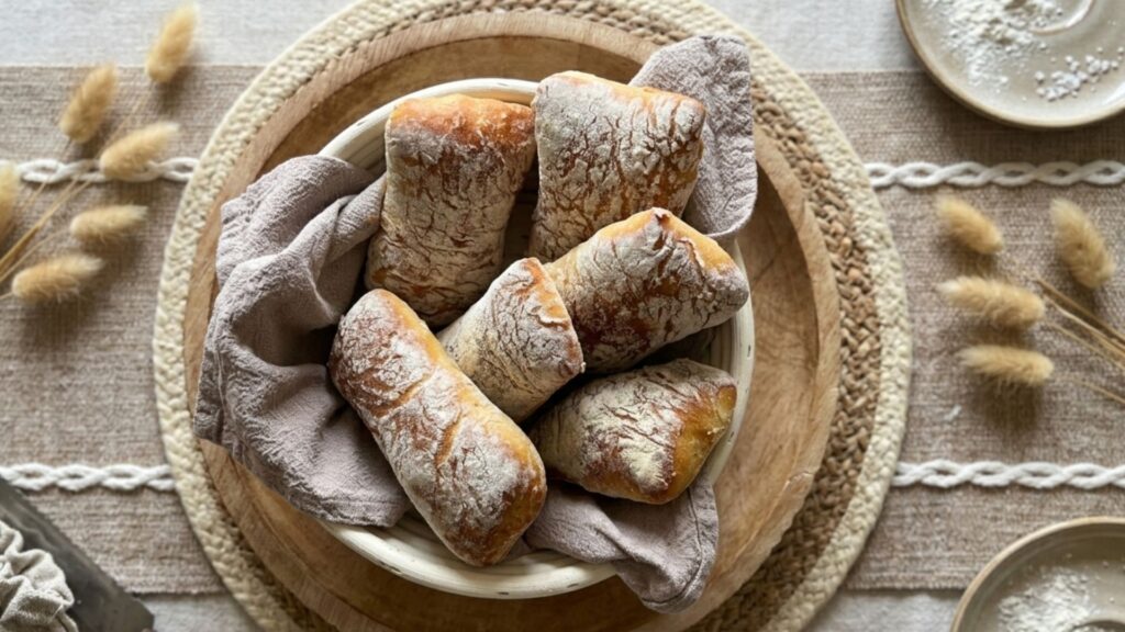 Basket of golden sourdough ciabatta pieces with an open, holey crumb