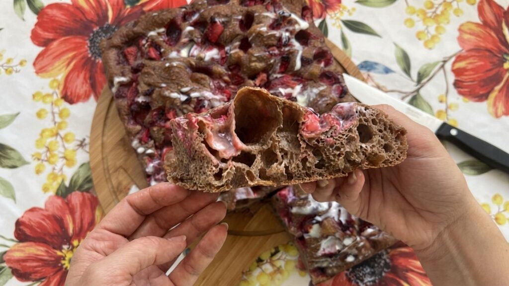 Chocolate sourdough focaccia topped with fresh diced strawberries and a mascarpone drizzle
