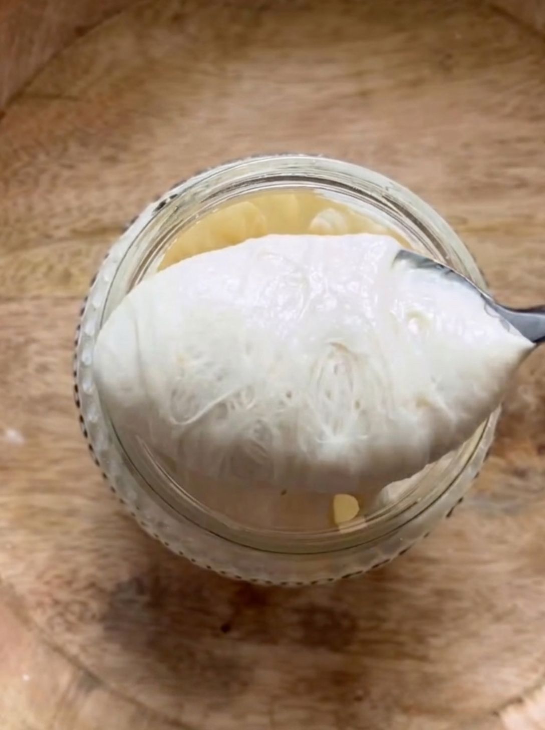 Sourdough starter scooped open showing an airy, webby texture inside