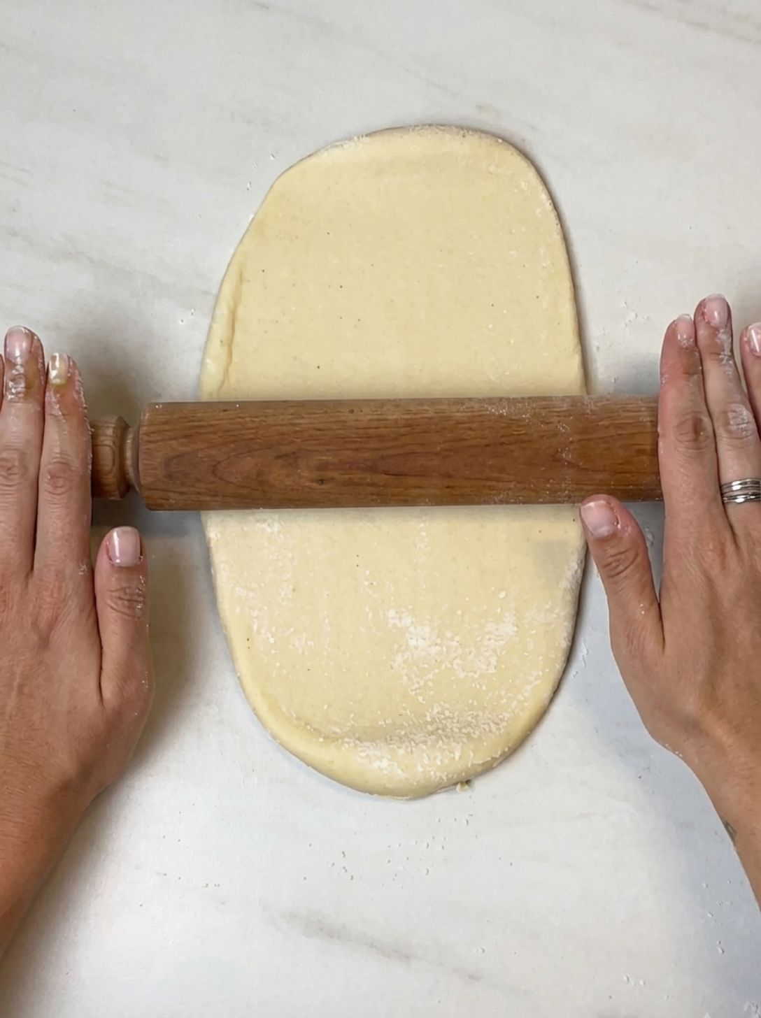 Rolling out chilled brioche dough into a rectangle