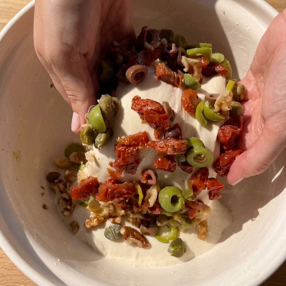 Adding walnuts, olives, sun-dried tomatoes, and capers to sourdough breadstick dough